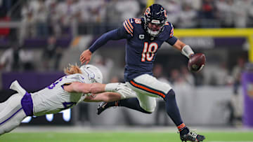Dec 16, 2024; Minneapolis, Minnesota, USA; Chicago Bears quarterback Caleb Williams (18) scrambles against the Minnesota Vikings linebacker Andrew Van Ginkel (43) in the second quarter at U.S. Bank Stadium. Mandatory Credit: Brad Rempel-Imagn Images