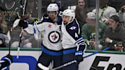Winnipeg Jets center Scheifele and defenseman Pionk celebrate a goal scored by Scheifele against the Dallas Stars in game six of the second round of the 2025 Stanley Cup Playoffs at American Airlines Center. 