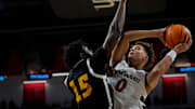 Nov 4, 2024; Cincinnati, OH, USA; Cincinnati Bearcats guard Dan Skillings Jr. (0) drives against Arkansas-Pine Bluff Golden Lions forward Dennis Asoro (15) in the second half of the NCAA mens basketball game between the Cincinnati Bearcats and the Arkansas-Pine Bluff Golden Lions at Fifth Third Arena on the University of Cincinnati campus on Monday, Nov. 4, 2024. The Bearcats won 109-54. Mandatory Credit: Sam Greene/USA TODAY Network via Imagn Images 