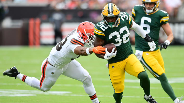 Aug 10, 2024; Cleveland, Ohio, USA; Green Bay Packers running back MarShawn Lloyd (32) runs with the ball as Cleveland Browns linebacker Caleb Johnson (48) defends during the second half at Cleveland Browns Stadium. Mandatory Credit: Ken Blaze-USA TODAY Sports