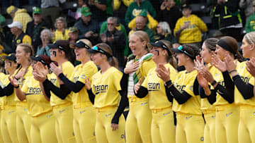 The Oregon softball team lines up for the National Anthem before their game against Michigan State at Jane Sanders Stadium.