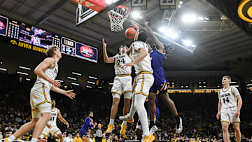 Nov 7, 2025; Iowa City, Iowa, USA; Iowa Hawkeyes guard Tate Sage (24) grabs a rebound as guard Bennett Stirtz (14) and forward Cooper Koch (8) look on against the Western Illinois Leathernecks during the first half at Carver-Hawkeye Arena. Mandatory Credit: Jeffrey Becker-Imagn Images