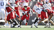 Oct 4, 2025; Louisville, Kentucky, USA; Louisville Cardinals running back Isaac Brown (1) runs the ball against the Virginia Cavaliers during the second quarter at L&N Federal Credit Union Stadium. Mandatory Credit: Jamie Rhodes-Imagn Images