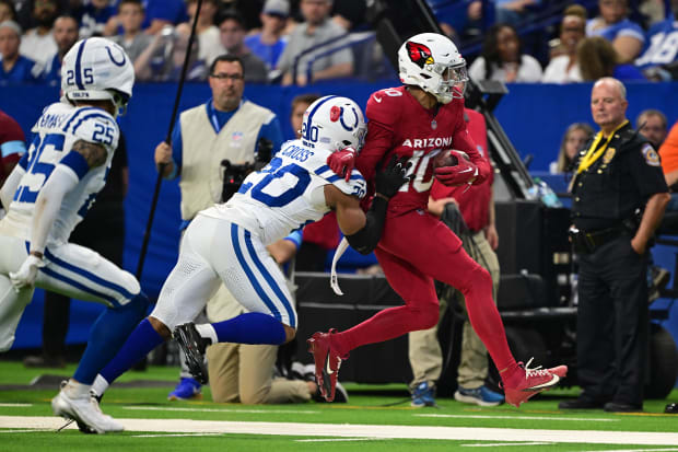 Football player Nick Cross makes a play on the receiver in a white jersey.