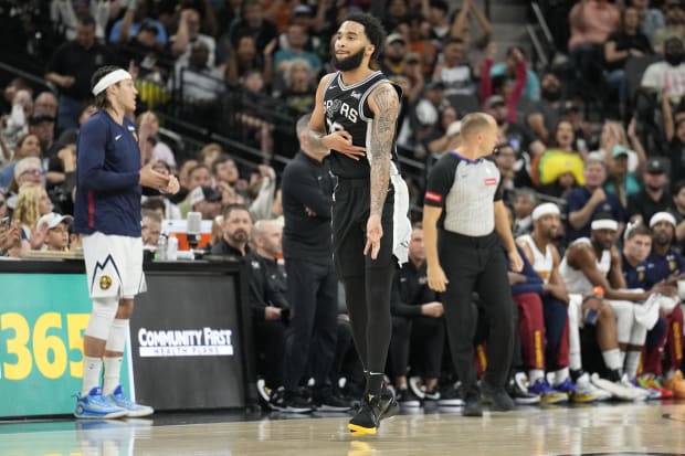 San Antonio Spurs forward Julian Champagnie reacts after scoring a 3-point basket during the second half against the Nuggets.