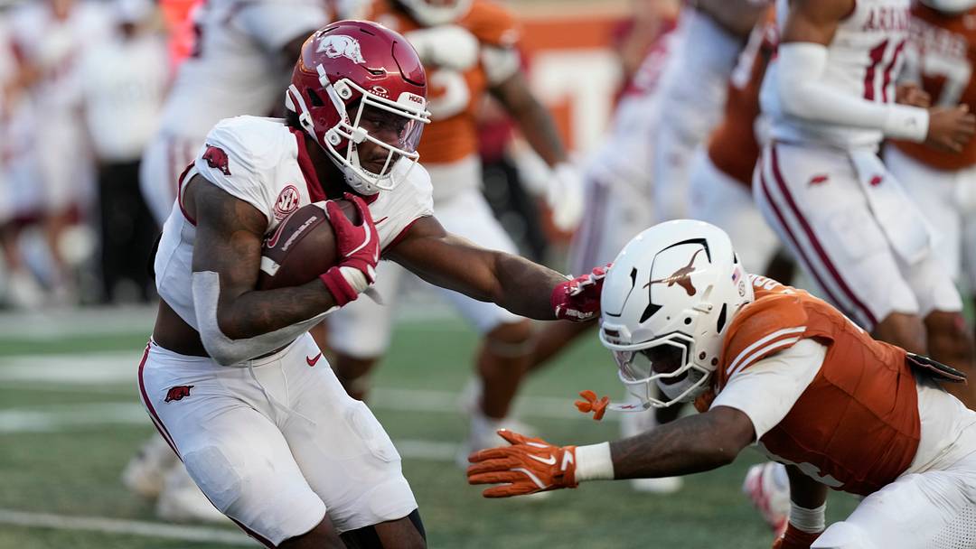 Arkansas Razorbacks quarterback KJ Jackson runs from the pocket while defended by Texas Longhorns defensive back Jelani McDonald during the second half at Darrell K Royal-Texas Memorial Stadium. Arkansas Razorbacks quarterback KJ Jackson runs from the pocket while defended by Texas Longhorns defensive back Jelani McDonald during the second half at Darrell K Royal-Texas Memorial Stadium.