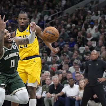Apr 25, 2025; Milwaukee, Wisconsin, USA; Milwaukee Bucks guard Damian Lillard (0) drives to the basket gains Indiana Pacers center Myles Turner (33) and forward Aaron Nesmith (23) in the second half during game three of first round for the 2024 NBA Playoffs at Fiserv Forum. Mandatory Credit: Michael McLoone-Imagn Images