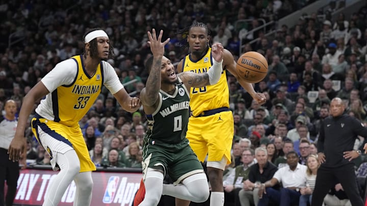 Apr 25, 2025; Milwaukee, Wisconsin, USA; Milwaukee Bucks guard Damian Lillard (0) drives to the basket gains Indiana Pacers center Myles Turner (33) and forward Aaron Nesmith (23) in the second half during game three of first round for the 2024 NBA Playoffs at Fiserv Forum. Mandatory Credit: Michael McLoone-Imagn Images