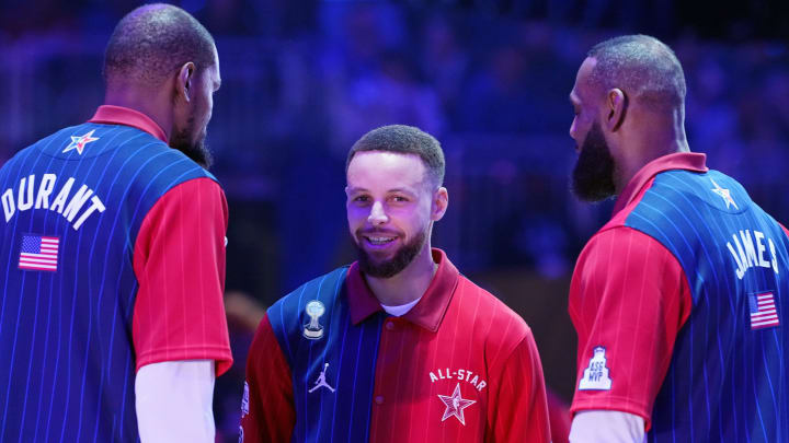 Stephen Curry (30) of the Golden State Warriors talks with forward Kevin Durant (35) of the Phoenix Suns and forward LeBron James (23) of the Los Angeles Lakers before the 73rd NBA All Star game at Gainbridge Fieldhouse. 