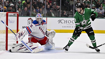 Dec 20, 2024; Dallas, Texas, USA; Dallas Stars center Mavrik Bourque (22) attempts to redirect the puck past New York Rangers goaltender Igor Shesterkin (31) during the second period at the American Airlines Center. Mandatory Credit: Jerome Miron-Imagn Images