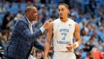 Feb 22, 2025; Chapel Hill, North Carolina, USA; North Carolina Tar Heels head coach Hubert Davis talks to guard Seth Trimble (7) in the first half at Dean E. Smith Center. Mandatory Credit: Bob Donnan-Imagn Images