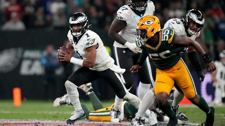 Philadelphia Eagles quarterback Jalen Hurts (1) scrambles against Green Bay Packers defensive end Kingsley Enagbare on Friday.