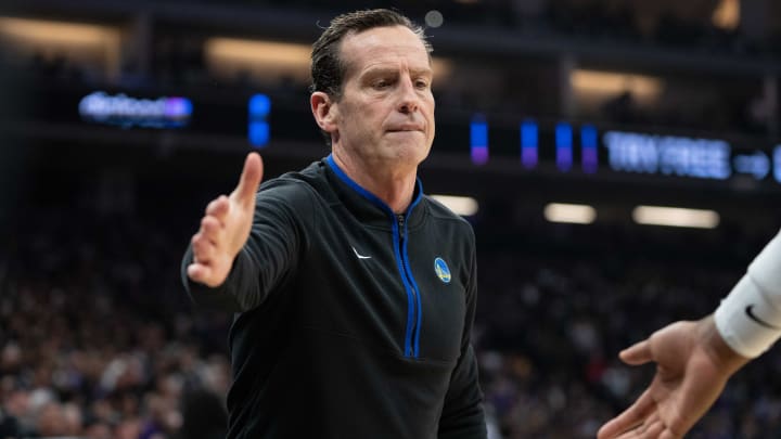 Warriors assistant coach Kenny Atkinson high-fives a player during the NBA play-in tournament.