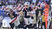 Nov 2, 2025; Foxborough, Massachusetts, USA; New England Patriots quarterback Drake Maye (10) hands the ball off to running back TreVeyon Henderson (32) during the first quarter at Gillette Stadium. Mandatory Credit: Eric Canha-Imagn Images