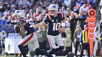 Nov 2, 2025; Foxborough, Massachusetts, USA; New England Patriots quarterback Drake Maye (10) hands the ball off to running back TreVeyon Henderson (32) during the first quarter at Gillette Stadium. Mandatory Credit: Eric Canha-Imagn Images