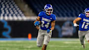 Detroit Catholic Central Jalen Montlouis (24) runs the ball during the Prep Bowl against Detroit King at Ford Field in Detroit on Saturday, Oct. 25, 2025.