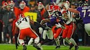 Jan 4, 2025; Baltimore, Maryland, USA; Baltimore Ravens wide receiver Zay Flowers (4) runs the ball as Cleveland Browns defensive end Ogbo Okoronkwo (54) defends during the second quarter at M&T Bank Stadium. Mandatory Credit: Mitch Stringer-Imagn Images