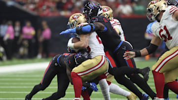 The Houston Texans defense swarms to the ball to stop San Francisco 49ers superstar running back Christian McCaffrey