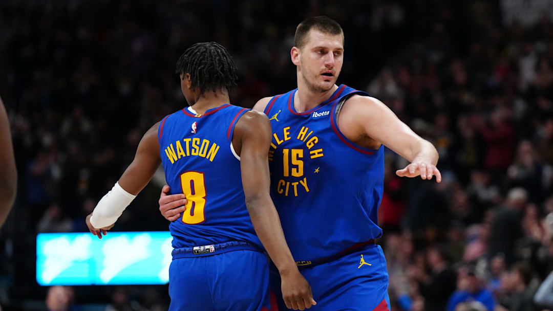 Mar 5, 2024; Denver, Colorado, USA; Denver Nuggets forward Peyton Watson (8) and center Nikola Jokic (15) react in the first half against the Phoenix Suns at Ball Arena. Mandatory Credit: Ron Chenoy-Imagn Images