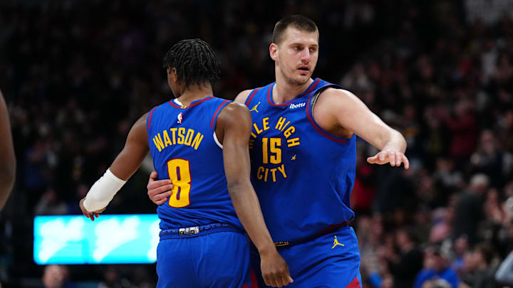 Mar 5, 2024; Denver, Colorado, USA; Denver Nuggets forward Peyton Watson (8) and center Nikola Jokic (15) react in the first half against the Phoenix Suns at Ball Arena. Mandatory Credit: Ron Chenoy-Imagn Images
