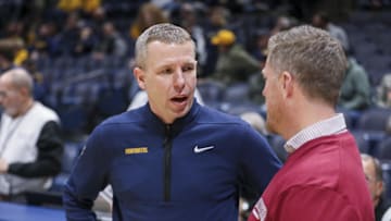 Nov 17, 2025; Morgantown, West Virginia, USA; West Virginia Mountaineers head coach Ross Hodge talks with Lafayette Leopards head coach Mike McGarvey before the game at WVU Coliseum. Mandatory Credit: Ben Queen-Imagn Images