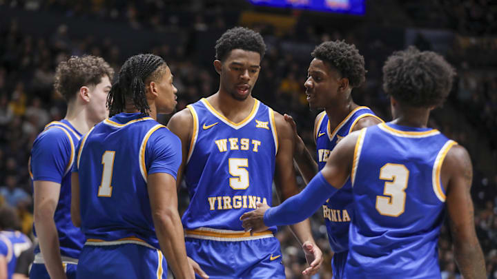 Jan 31, 2026; Morgantown, West Virginia, USA; West Virginia Mountaineers forward DJ Thomas (5) celebrates with teammates during the first half against the Baylor Bears at Hope Coliseum. Mandatory Credit: Ben Queen-Imagn Images