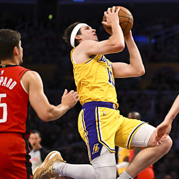 Apr 11, 2025; Los Angeles, California, USA; Los Angeles Lakers guard Austin Reaves (15) shoots against Houston Rockets center Jock Landale (2) during the first half at Crypto.com Arena. Mandatory Credit: Jonathan Hui-Imagn Images