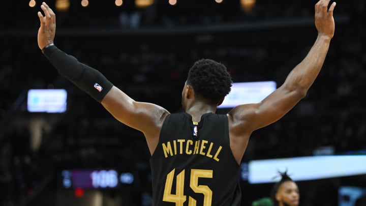 Nov 2, 2022; Cleveland, Ohio, USA; Cleveland Cavaliers guard Donovan Mitchell (45) quiets the crowd as guard Darius Garland (10) attempts a free throw during the second half against the Boston Celtics at Rocket Mortgage FieldHouse. Mandatory Credit: Ken Blaze-USA TODAY Sports