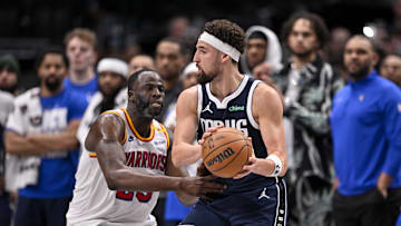 Feb 12, 2025; Dallas, Texas, USA; Golden State Warriors forward Draymond Green (23) and Dallas Mavericks guard Klay Thompson (31) in action during the game between the Dallas Mavericks and the Golden State Warriors at the American Airlines Center. Mandatory Credit: Jerome Miron-Imagn Images