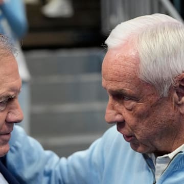 Jan 18, 2025; Chapel Hill, North Carolina, USA; North Carolina Tar Heels head football coach Bill Belichick with former Tar Heels basketball coach Roy Williams before the game at Dean E. Smith Center. Mandatory Credit: Bob Donnan-Imagn Images