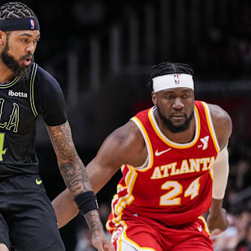 Mar 10, 2024; Atlanta, Georgia, USA; New Orleans Pelicans forward Brandon Ingram (14) dribbles behind Atlanta Hawks forward Bruno Fernando (24) during the second half at State Farm Arena.