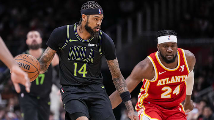 Mar 10, 2024; Atlanta, Georgia, USA; New Orleans Pelicans forward Brandon Ingram (14) dribbles behind Atlanta Hawks forward Bruno Fernando (24) during the second half at State Farm Arena.