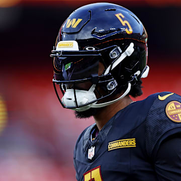 Aug 25, 2024; Landover, Maryland, USA; Washington Commanders quarterback Jayden Daniels (5) warms up before playing a preseason game against the New England Patriots at Commanders Field. Mandatory Credit: Peter Casey-Imagn Images