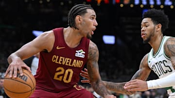 Oct 12, 2025; Boston, Massachusetts, USA; Cleveland Cavaliers guard/forward Jaylon Tyson (20) drives to the basket against Boston Celtics guard Anfernee Simons (4) during the second half at TD Garden. Mandatory Credit: Brian Fluharty-Imagn Images