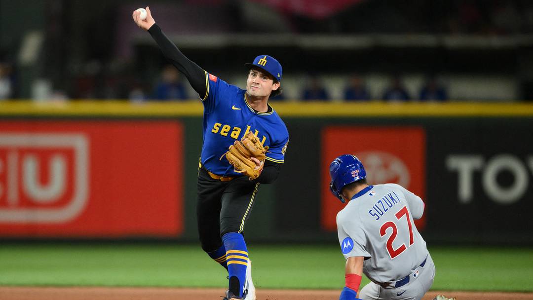 Aug 21, 2026; Seattle, Washington, USA; Seattle Mariners second baseman Cole Young (2) throws to first base to complete the double play against the Chicago Cubs during the seventh inning at T-Mobile Park. Mandatory Credit: Steven Bisig-Imagn Images