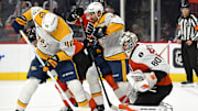 Oct 30, 2025; Philadelphia, Pennsylvania, USA; Nashville Predators center Fedor Svechkov (40) tries to control the puck in front of Philadelphia Flyers goaltender Dan Vladar (80) during the second period at Xfinity Mobile Arena. Mandatory Credit: Eric Hartline-Imagn Images