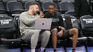 Mar 31, 2024; Sacramento, California, USA; Sacramento Kings assistant coach Luke Loucks (left) talks with guard De'Aaron Fox (right) before the game against the Utah Jazz at Golden 1 Center. Mandatory Credit: Darren Yamashita-Imagn Images