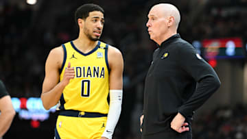 Indiana Pacers guard Tyrese Haliburton (0) and head coach Rick Carlisle during a game against the Cleveland Cavaliers.