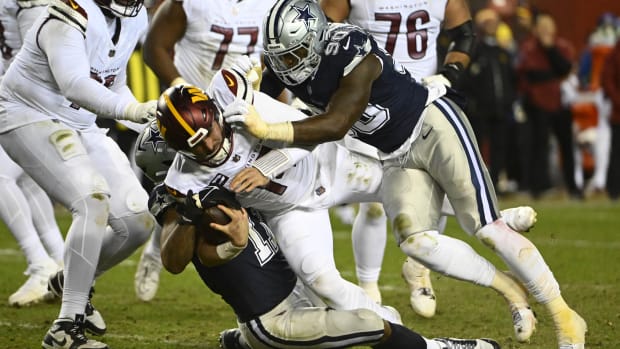 Jan 7, 2024; Landover, Maryland, USA; Dallas Cowboys linebacker Micah Parsons (11) and defensive end DeMarcus Lawrence (90) sack Washington Commanders quarterback Sam Howell (14) during the second half at FedExField. 