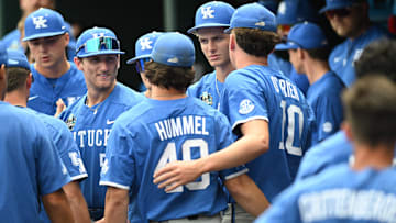 Jun 19, 2024; Omaha, NE, USA;  Kentucky Wildcats pitcher Johnny Hummel (49) and pitcher Cameron O'Brien (10) and teammates gather after the loss against the Florida Gators at Charles Schwab Field Omaha. Mandatory Credit: Steven Branscombe-Imagn Images