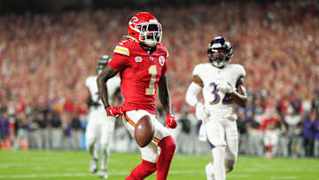 Sep 5, 2024; Kansas City, Missouri, USA; Kansas City Chiefs wide receiver Xavier Worthy (1) scores a touchdown against Baltimore Ravens safety Marcus Williams (32) during the first half at GEHA Field at Arrowhead Stadium.