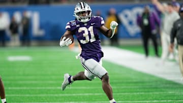 Dec 28, 2023; Orlando, FL, USA; Kansas State running back DJ Giddens (31) runs the ball against NC State in the fourth quarter at Camping World Stadium. Mandatory Credit: Jeremy Reper-Imagn Images
