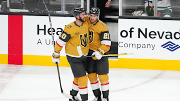 Apr 20, 2025; Las Vegas, Nevada, USA; Vegas Golden Knights center Brett Howden (21) celebrates with Vegas Golden Knights center Nicolas Roy (10) after scoring an empty net goal against the Minnesota Wild during the third period of game one of the first round of the 2025 Stanley Cup Playoffs at T-Mobile Arena. Mandatory Credit: Stephen R. Sylvanie-Imagn Images
