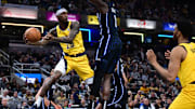 Apr 11, 2025; Indianapolis, Indiana, USA; Indiana Pacers guard Quenton Jackson (29) passes the ball around Orlando Magic forward Jonathan Isaac (1) during the second quarter at Gainbridge Fieldhouse. Mandatory Credit: Marc Lebryk-Imagn Images