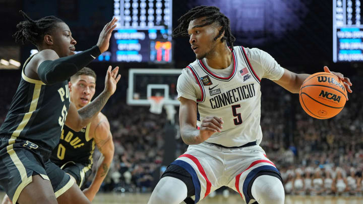 Apr 8, 2024; Glendale, AZ, USA; Connecticut Huskies guard Stephon Castle (5) dribbles the ball against Purdue Boilermakers guard Myles Colvin (5) during the first half of the national championship game of the Final Four of the 2024 NCAA Tournament at State Farm Stadium. 