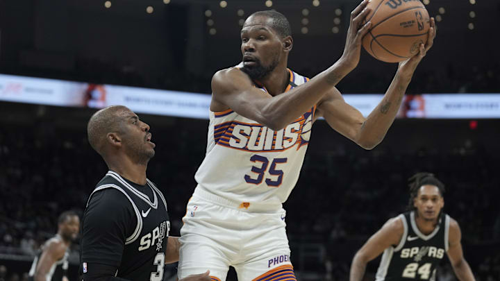 Feb 20, 2025; Austin, Texas, USA; Phoenix Suns forward Kevin Durant (35) looks to drive to the basket while defended by San Antonio Spurs guard Chris Paul (3) during the first half at Moody Center. Mandatory Credit: Scott Wachter-Imagn Images