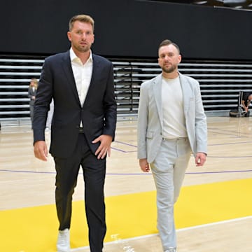 Aug 2, 2025; El Segundo, CA, USA; Los Angeles Lakers Luka Doncic (77) walks with team communications director Mitch Heckart following a press conference announcing the signing of a 3-year, $165 million contract extension at UCLA Health Training Center. Mandatory Credit: Jayne Kamin-Oncea-Imagn Images
