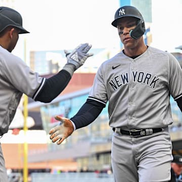 Apr 25, 2023; Minneapolis, Minnesota, USA; New York Yankees center fielder Aaron Judge (99) celebrates with second baseman Oswald Peraza (91) after scoring a run on a single by third baseman DJ LeMahieu during the first inning at Target Field. Mandatory Credit: Jeffrey Becker-Imagn Images
