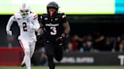 Cincinnati Bearcats running back Tawee Walker (3) runs for 54-yards as Arizona Wildcats defensive back Treydan Stukes (2) chases in the first quarter of the NCAA football game between the Cincinnati Bearcats and Arizona Wildcats at Nippert Stadium in Cincinnati on Nov. 15, 2025.