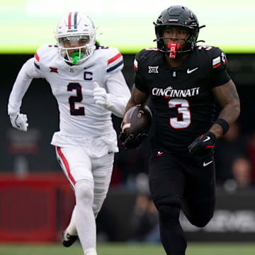 Cincinnati Bearcats running back Tawee Walker (3) runs for 54-yards as Arizona Wildcats defensive back Treydan Stukes (2) chases in the first quarter of the NCAA football game between the Cincinnati Bearcats and Arizona Wildcats at Nippert Stadium in Cincinnati on Nov. 15, 2025.
